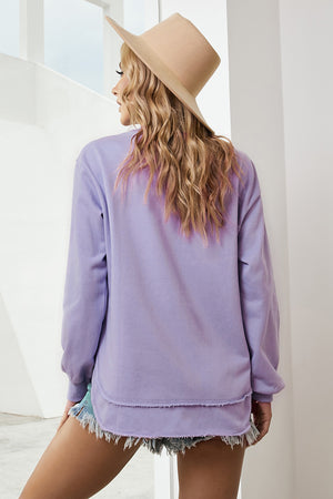 Purple sweatshirt with asymmetric hemline and raw edge detail.