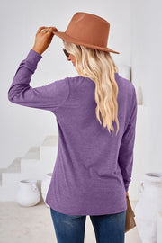 Lavender henley neckline jersey top with long sleeves.