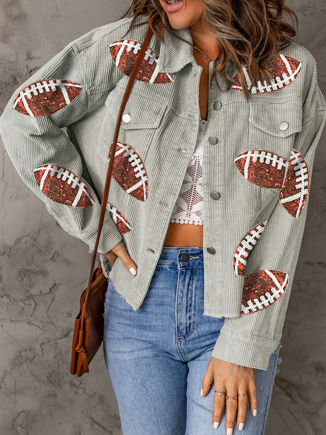 Sage corduroy overshirt with allover football embellishments, button front, and chest pockets.