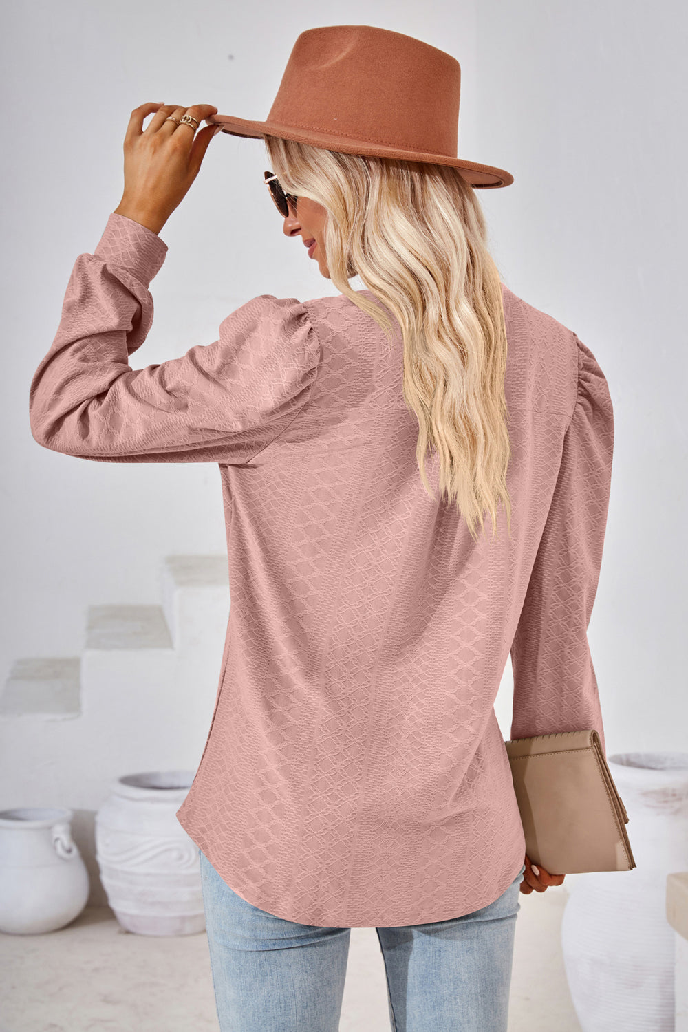 Pink textured blouse with bishop sleeves and a subtle diamond pattern.