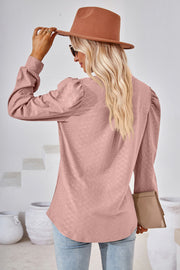 Pink textured blouse with bishop sleeves and a subtle diamond pattern.