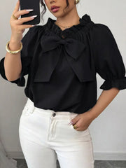 Black ruffled bow sleeve blouse with cinched cuffs.
