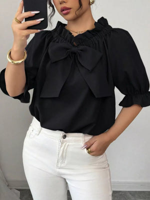 Black ruffled bow sleeve blouse with cinched cuffs.