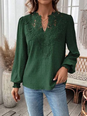 Dark green embroidered yoke blouse with puff sleeves and textured fabric.