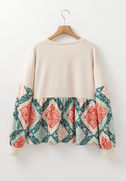 Beige peplum knit top with patchwork paisley print sleeves and hem