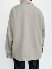 Oversized button-down jacket in khaki with long sleeves and a classic collar.
