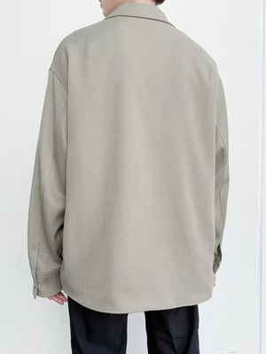 Oversized button-down jacket in khaki with long sleeves and a classic collar.