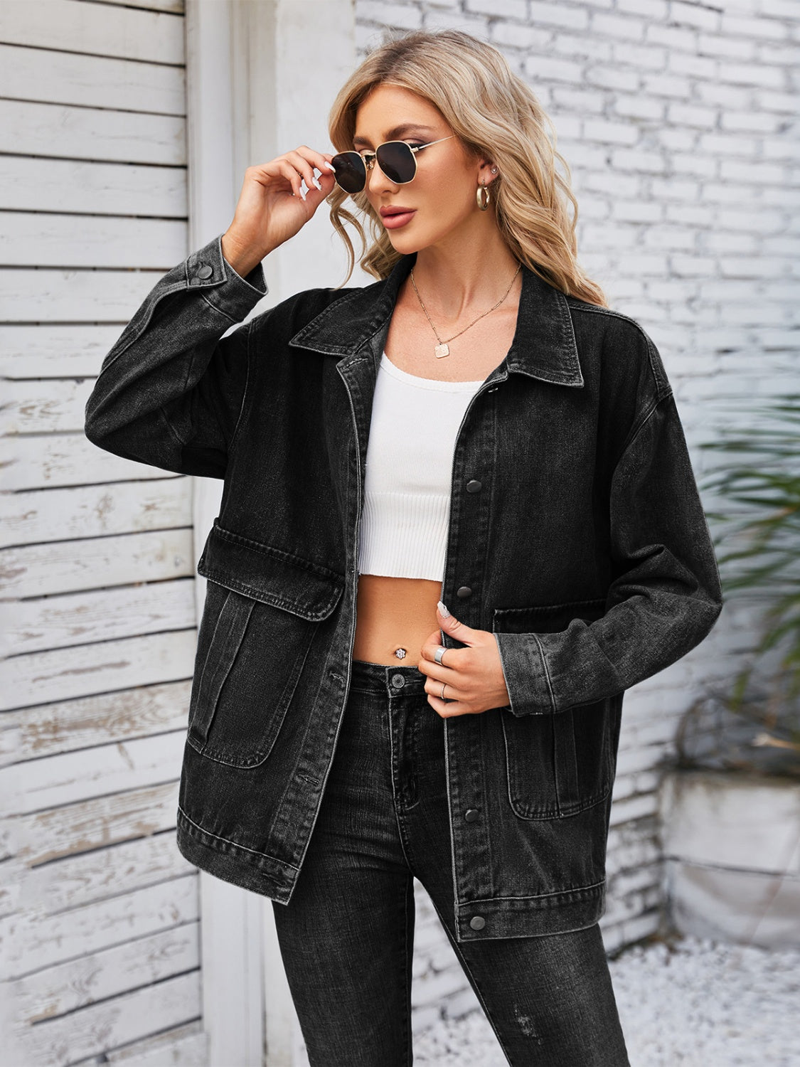 Black denim button-up jacket with chest pockets and collar.