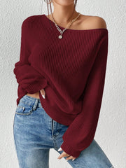 Burgundy ribbed knit off-shoulder top with balloon sleeves, styled with jeans.