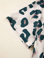 Print short sleeve blouse with animal print pattern and crew neck.