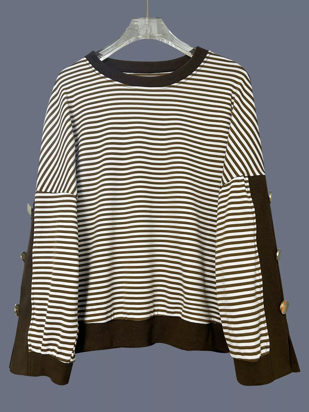 Brown and white striped sweatshirt with decorative buttons on the side seams.