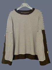 Brown and white striped sweatshirt with decorative buttons on the side seams.