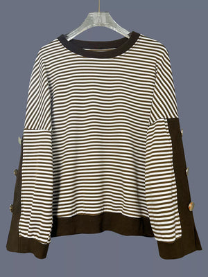 Brown and white striped sweatshirt with decorative buttons on the side seams.