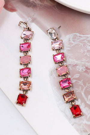 Ombre gemstone cascade earrings with pink, red, and clear stones on gold alloy.