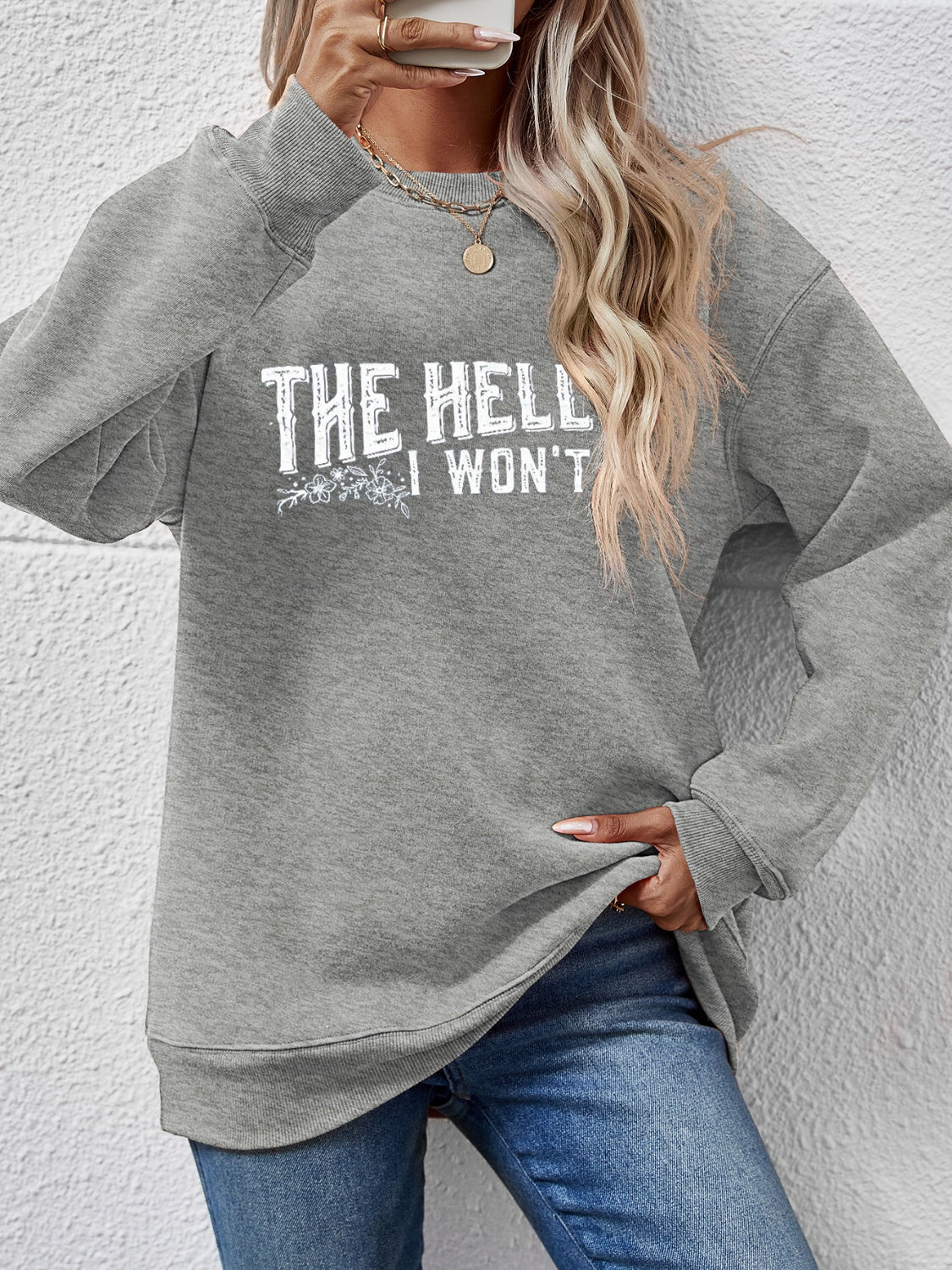 Graphic crewneck sweatshirt in charcoal with white text and floral detail, crew neck, long sleeves.