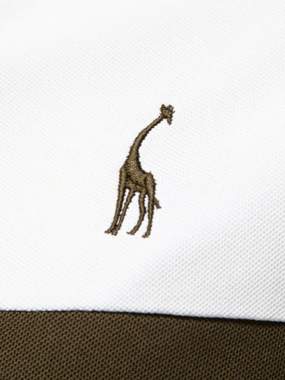 White polo shirt with brown giraffe embroidery and olive green stripe detail.