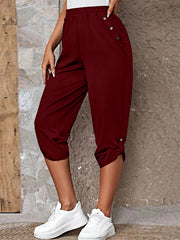 Burgundy culottes with button details and cuffed hems, styled with white sneakers.