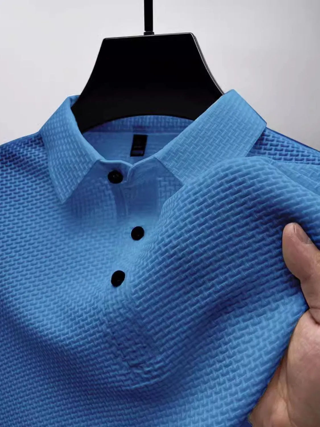 Blue textured weave polo shirt with maxi collar and black buttons