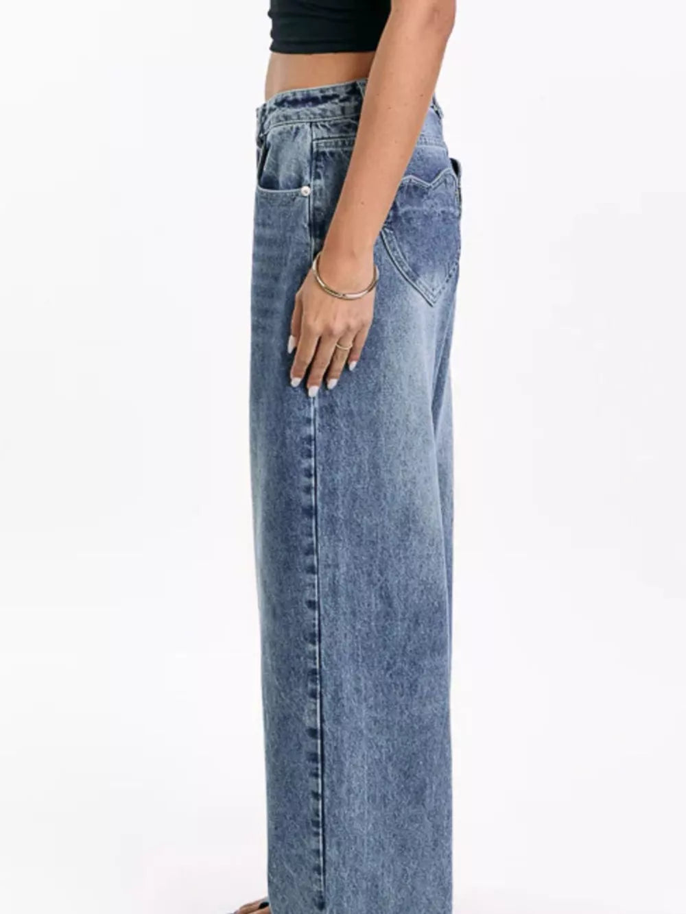 Blue denim wide-leg jeans with functional pockets and a heart-shaped back pocket detail.
