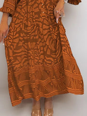 Brown abstract print midi dress with button detail and tiered hem.