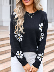 Black acrylic knit sweater with white daisy intarsia pattern, crew neck, long sleeves.