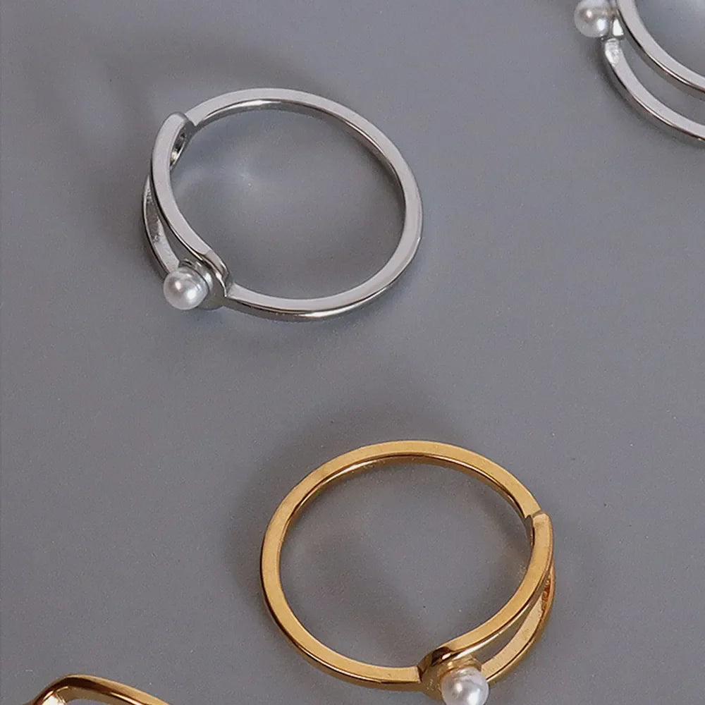 Sculptural ring in gold and silver with a pearl accent detail.