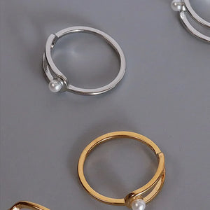 Sculptural ring in gold and silver with a pearl accent detail.