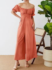 Coral off-the-shoulder jumpsuit with ruched waist and wide legs