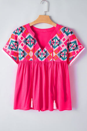 Strawberry embroidered yoke tie-neckline blouse with short sleeves and tassel details.