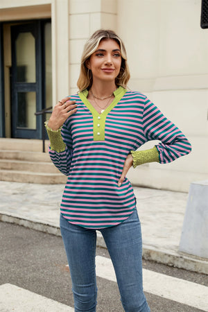 Striped long sleeve blouse with green neckline and cuffs, button detail.