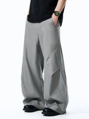 Grey relaxed fit oversized men's sweatpants with wide leg and diagonal seam detail.