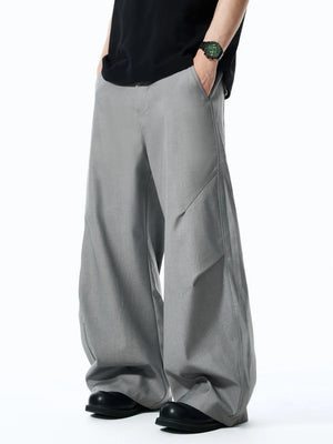 Grey relaxed fit oversized men's sweatpants with wide leg and diagonal seam detail.