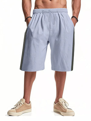 Light blue bermuda shorts with drawstring and side stripe detail.