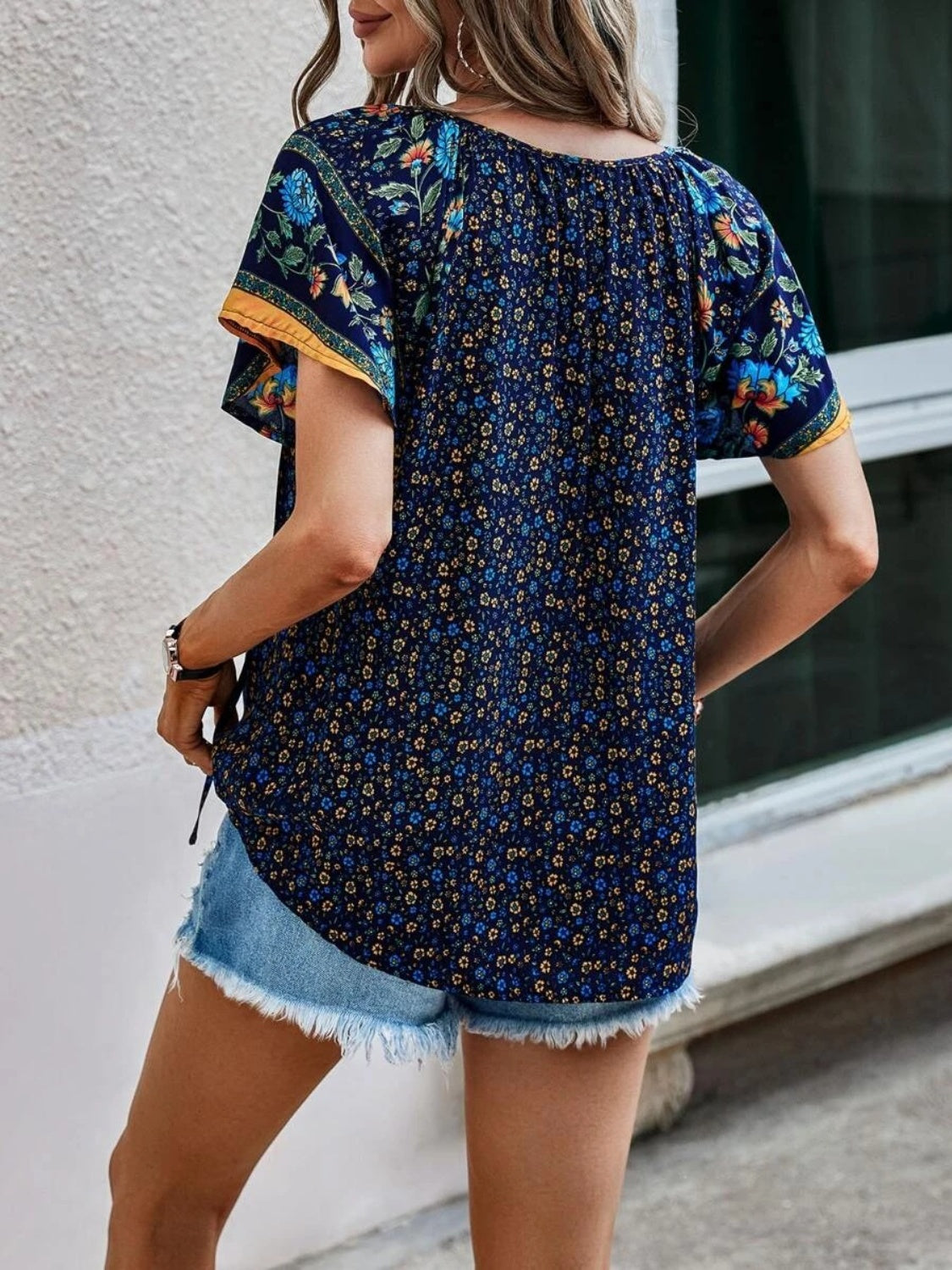 Dark blue bohemian floral print flutter sleeve blouse with yellow trim