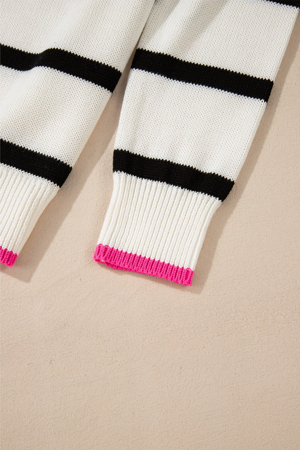 Contrast Trim Breton Knit sweater in stripe pattern with black stripes and pink cuffs.