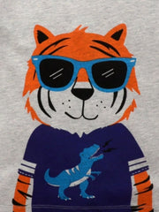 Toddler t-shirt with a grey cotton crew neck, featuring a tiger graphic wearing blue sunglasses and a blue dinosaur graphic.