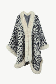 Leopard print cape with faux fur trim and cuffs. Beige and black pattern.