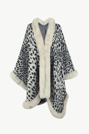 Leopard print cape with faux fur trim and cuffs. Beige and black pattern.