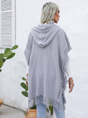 Gray knit poncho with fringe, crochet detail, and diamond pattern.