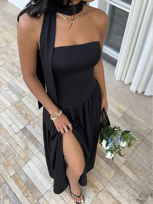 Black strapless maxi dress with asymmetrical scarf detail and high slit.
