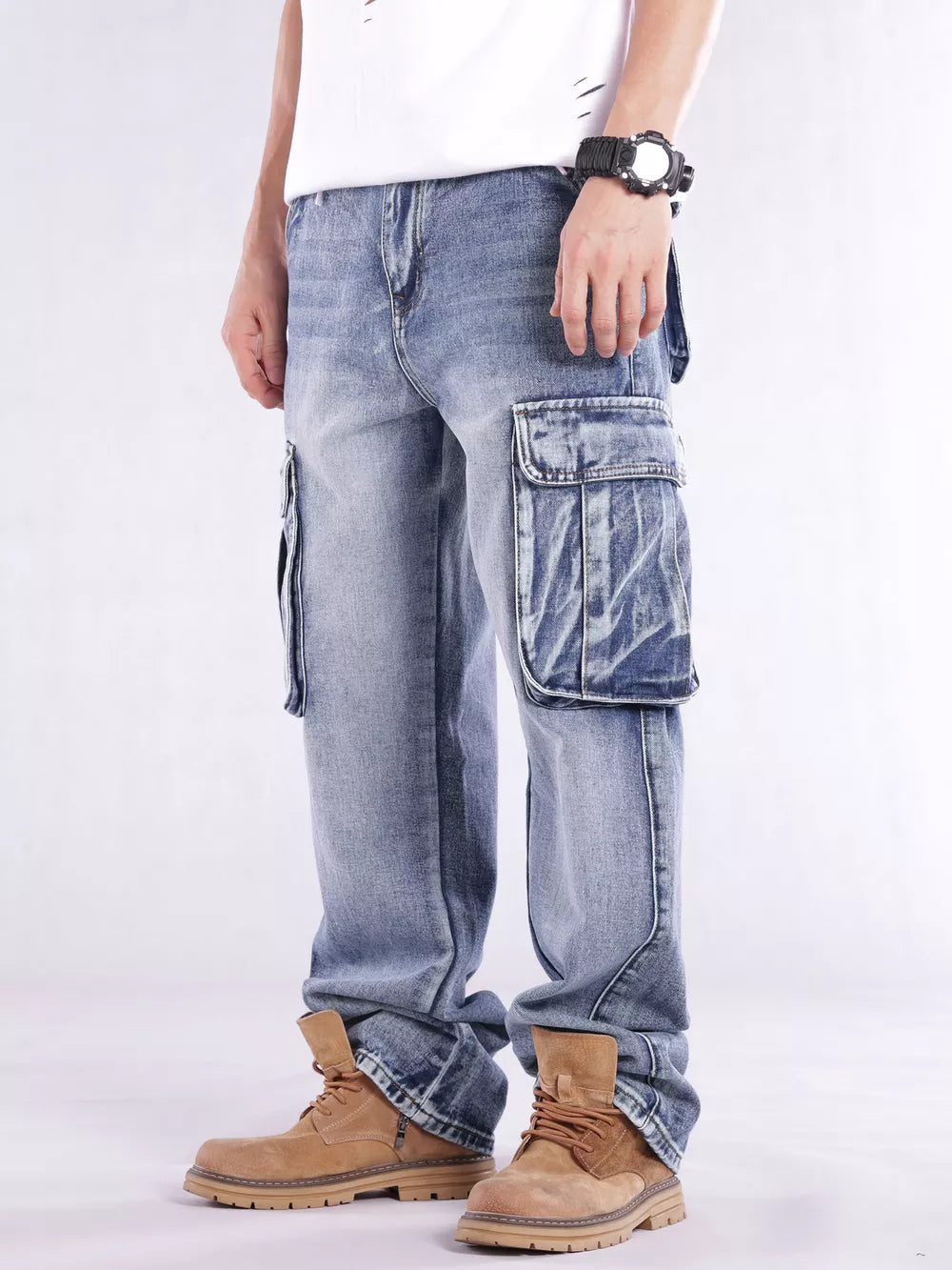 Relaxed fit light wash denim cargo jeans with flap pockets and contrast stitching.