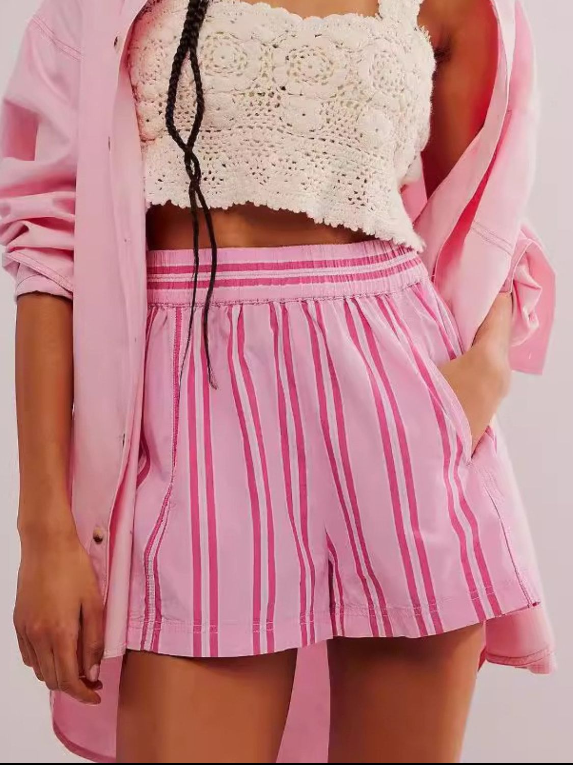 Watermelon pink striped shorts with elastic waistband and pockets.