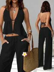 Black halter neck cami and drawstring relaxed pants set with a deep V-neck and tie back.
