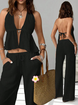 Black halter neck cami and drawstring relaxed pants set with a deep V-neck and tie back.