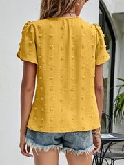 Textured puff sleeve mustard blouse with dot pattern and V-neck.