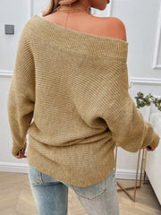 Tan off-the-shoulder knit sweater with pearl embellishments and ribbed texture.