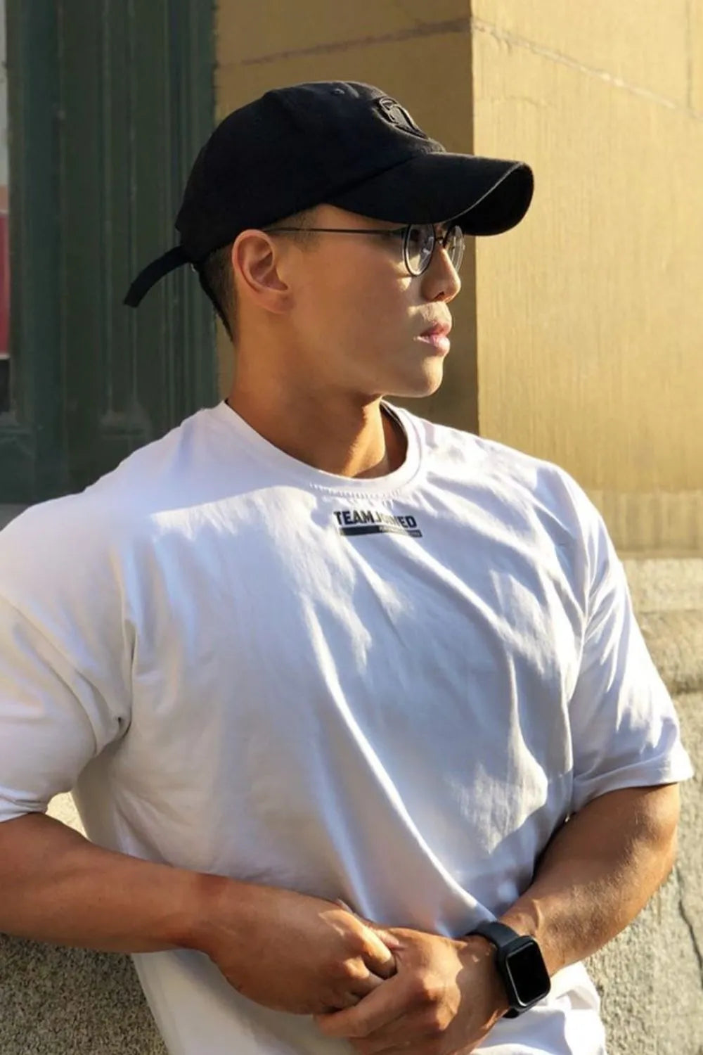 Oversized white t-shirt with a small black logo detail on the chest.