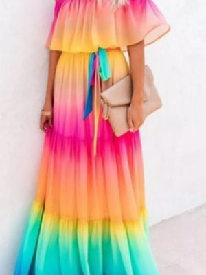Off-shoulder tiered maxi dress with rainbow ombre gradient and tie waist.