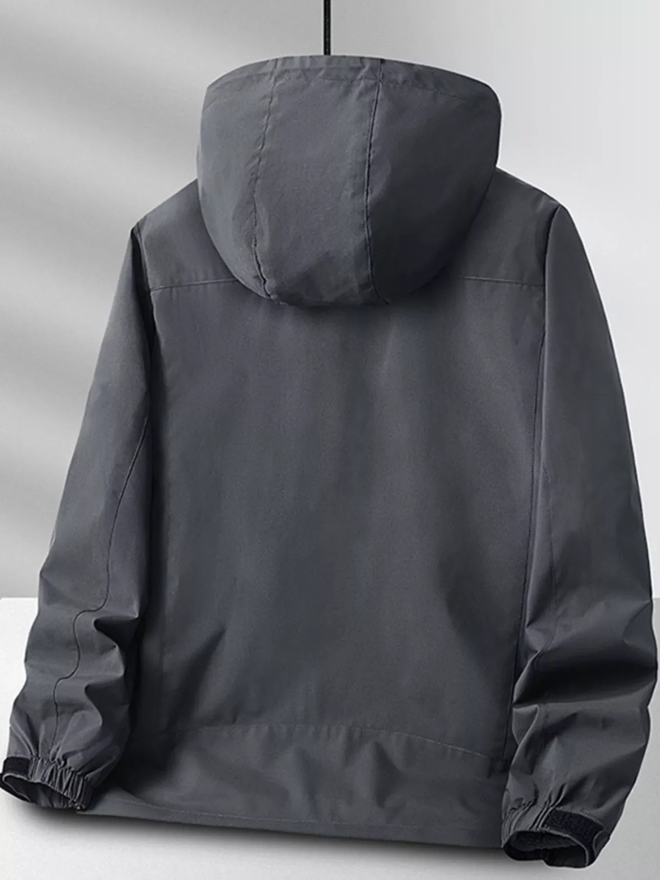 Grey hooded zip jacket with elastic cuffs and adjustable hem