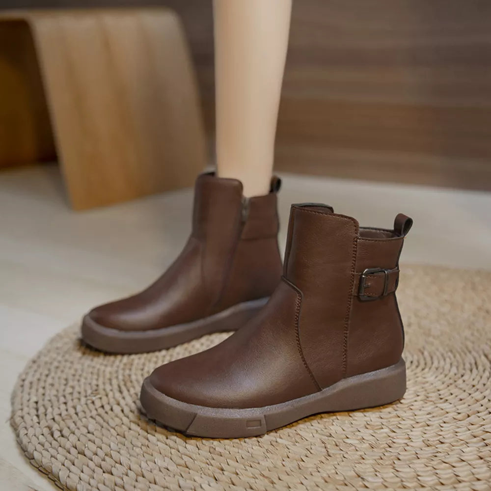 Brown leather ankle boots with round toe, decorative buckle and side zipper.